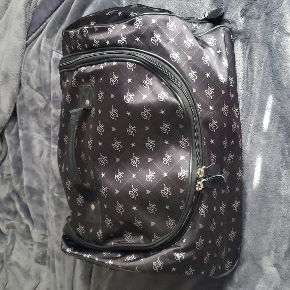 💎Paris Hilton Wheeled Duffel bag in black  and white, hot pink inside.